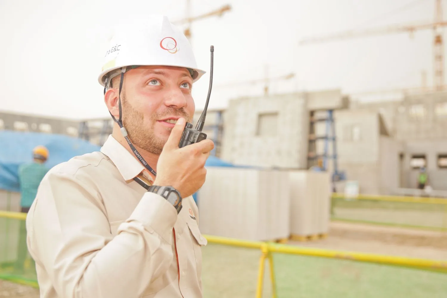 Foreman in a hi-vis hard hat directing the crew
