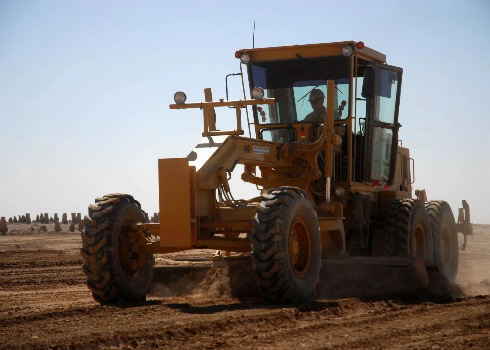 Grader at work — U.S. Navy photo by Ryan G. Wilber (public domain)