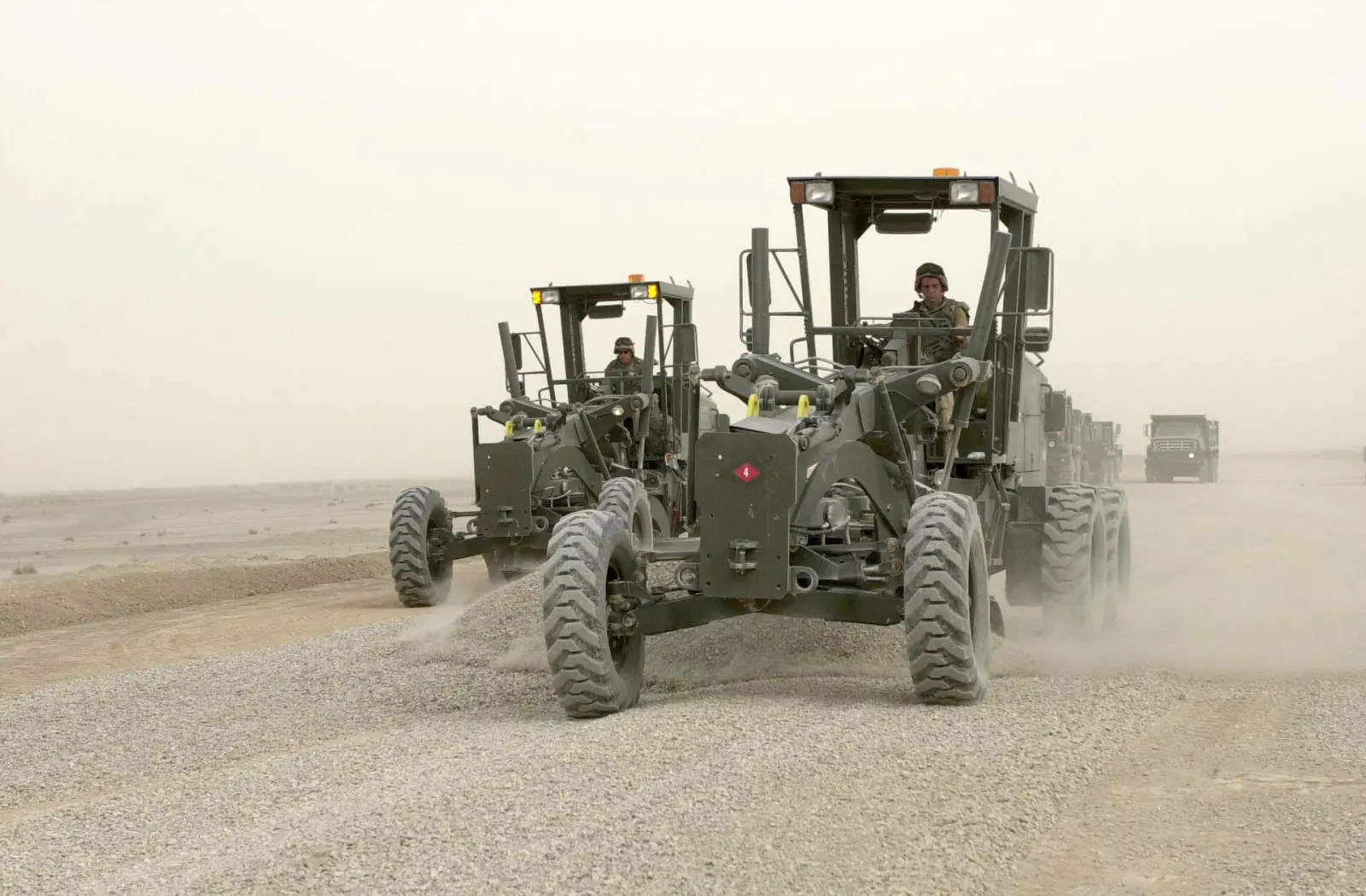 Road crew working in desert heat — U.S. Navy photo by Jacob Johns (public domain)